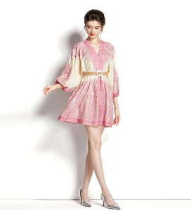Detailed side view of V-neck printed mini dress with lantern sleeves and woven belt