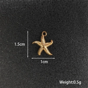 Detailed view of a gold starfish pendant with 1.5cm height and 1cm width measurements