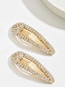 Close-up of dual gold metal water-drop hair clips with sparkling crystal rhinestones set
