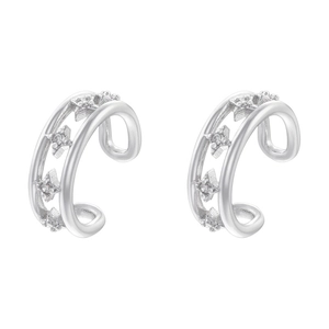 Detailed macro view of silver layered C-shaped ear cuffs with micro-inlaid star charms