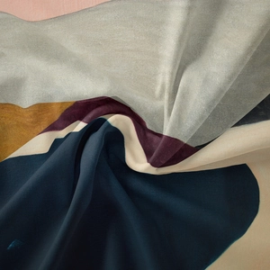 Detailed close-up of Bohemian tapestry fabric showing colorful abstract print and soft texture