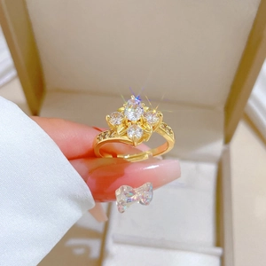 Detailed view of an adjustable gold-plated ring featuring a zircon flower cluster design
