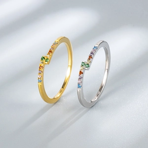 Detail of gold and silver S925 rings with rainbow zircon micro-pave setting