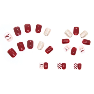 Christmas press-on nails set with red reindeer and snowman patterns on white background