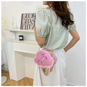 Detail of pink ice cream shaped crossbody bag with glitter sprinkles and gold chain
