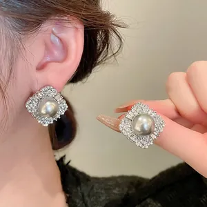 Silver needle butterfly pearl earrings with sparkling diamonds in a vintage square setting