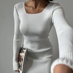 Detail of white ribbed knit fabric texture on a slim-fit long sleeve dress
