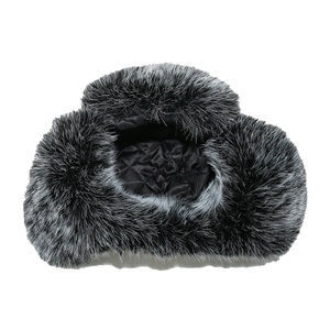 Detail of faux fox fur trapper hat featuring soft texture and black quilted lining