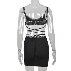 Detail of black two-piece beach set featuring lace trim and criss-cross waist ties