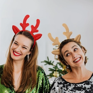 Close-up of red and gold plush reindeer antler headbands worn for Christmas festive events