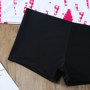 Detail of black high-elasticity swim shorts showing premium stitching and fabric texture
