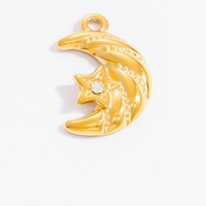Close-up of a 18k gold celestial pendant with moon and cubic zirconia star detail