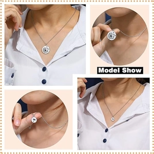 Detail view of dandelion engraved round pendant necklace on a model with white shirt