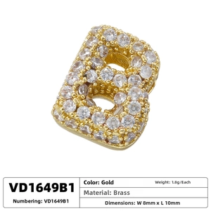 Macro detail of gold-plated brass letter B pendant with micro-paved cubic zirconia stones