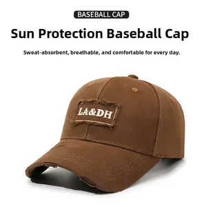 Detailed close-up of distressed brim and LA&DH letter embroidery on brown baseball cap