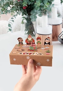 Close-up of Christmas kraft paper gift boxes with 3D cartoon animal character toppers