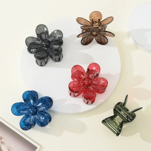 Detailed set of 5 floral hair claws in translucent resin with gold glitter finish