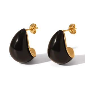 Detailed macro view of high-end water-drop shaped black and gold stainless steel earrings