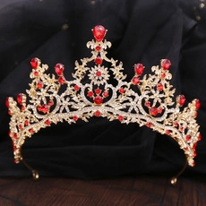 Close-up of vintage bridal crown featuring red gemstones and sparkling white rhinestones