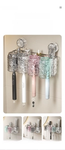 Detail of wall-mounted suction toothbrush holder set with multi-color drainage cups