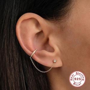 Detailed close-up of a 925 sterling silver tassel ear cuff chain with gold finish and small gems