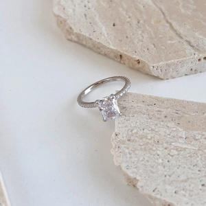Close-up of S925 silver ring featuring a radiant square zircon and Hallmark engraving