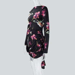 Detail view of the ruched side seam and floral print on a long-sleeve mini dress