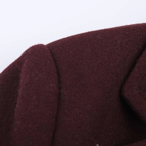 Detailed close-up showing the fine texture and stitching of dark red wool blend fabric