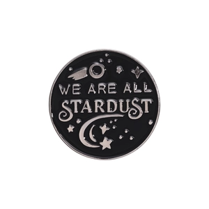 Retro round metal badge with Stardust lettering and cosmic celestial starry sky design