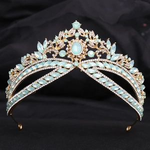 Detail of gold bridal crown with mint green opal stones and crystals on black silk