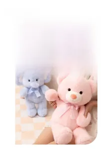 Detail of soft plush teddy bear and blue elephant dolls with bow tie decorations