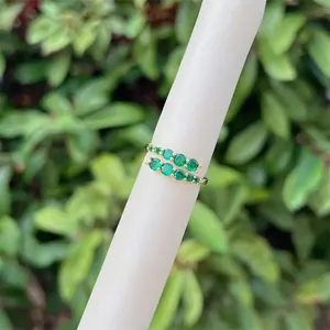 Detail of 18K gold plated double row ring with green zircon stones on white display