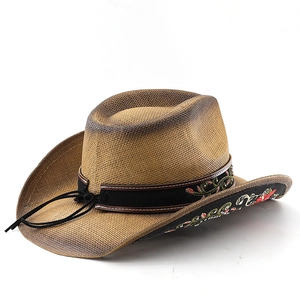 Detailed embroidery of red and green flowers on the black band of a brown cowboy hat