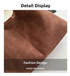 Macro shot of dark brown suede tote bag featuring high-quality stitching and matte texture