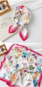 Detailed view of white floral satin scarf with vibrant tulip prints and magenta borders