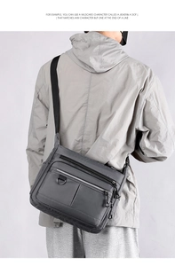 Detail of grey waterproof commuter messenger bag with multiple zipper compartments