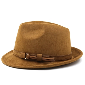 Close-up of caramel brown felt fedora featuring a leather band and gold buckle detail