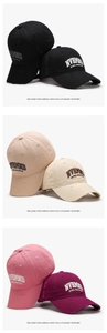 Close-up of distressed baseball caps with embroidered lettering in multiple colors