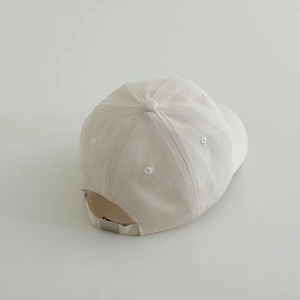 Detail view of cotton baseball cap with adjustable metal buckle and breathable eyelets