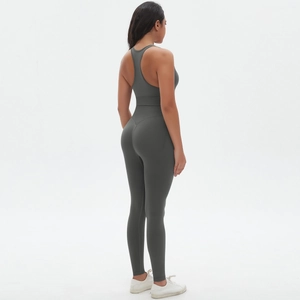 Back view of a seamless dark grey cross-back yoga jumpsuit for fitness and running