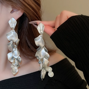 Detail of silver long petal tassel earrings with pearls on a matte metal finish