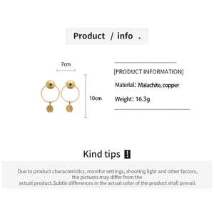 Detailed view of 24K gold plated earrings with green malachite stone and textured discs