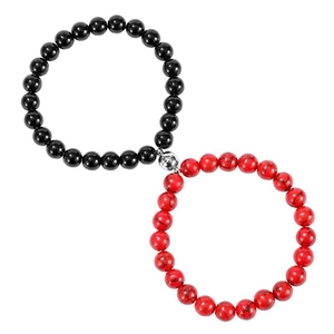 Detail of couple bracelets with magnetic silver clasp, black and red natural stone beads