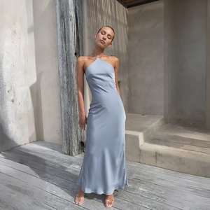 Detail of light blue satin halter neck dress showing backless design and silky texture