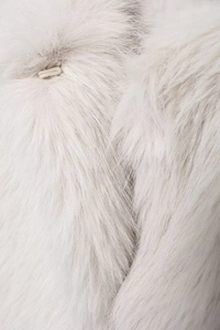 Macro shot of high-quality white faux fur texture showing the hidden metal hook closure