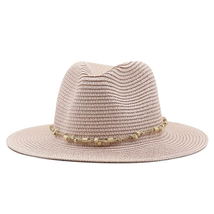 Detail of pink straw fedora with hemp rope and yellow beads decorative band