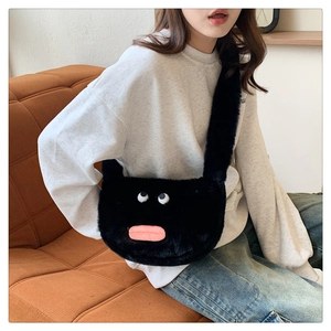 Detail showing the fluffy black plush bag with funny cartoon eyes and pink lips