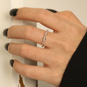 Rose gold S925 silver infinity ring with pavé zircons worn on hand with black nails
