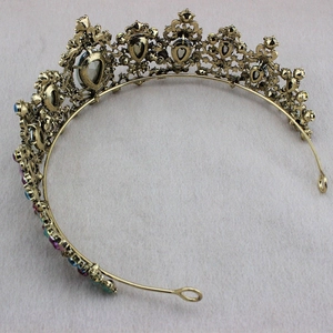 Detailed close-up of a vintage gold crown set with colorful oval and teardrop rhinestones