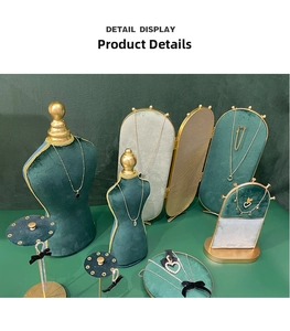 Detail of dark green velvet necklace bust display stands with golden metal frames